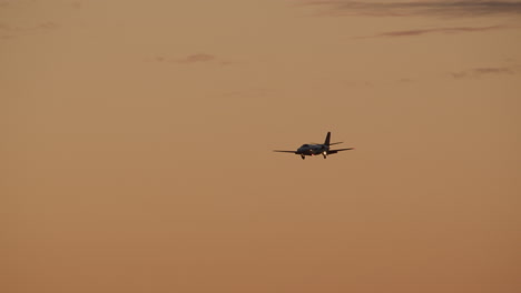 private jet landing at sunset