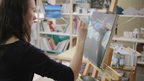 woman painting in art studio