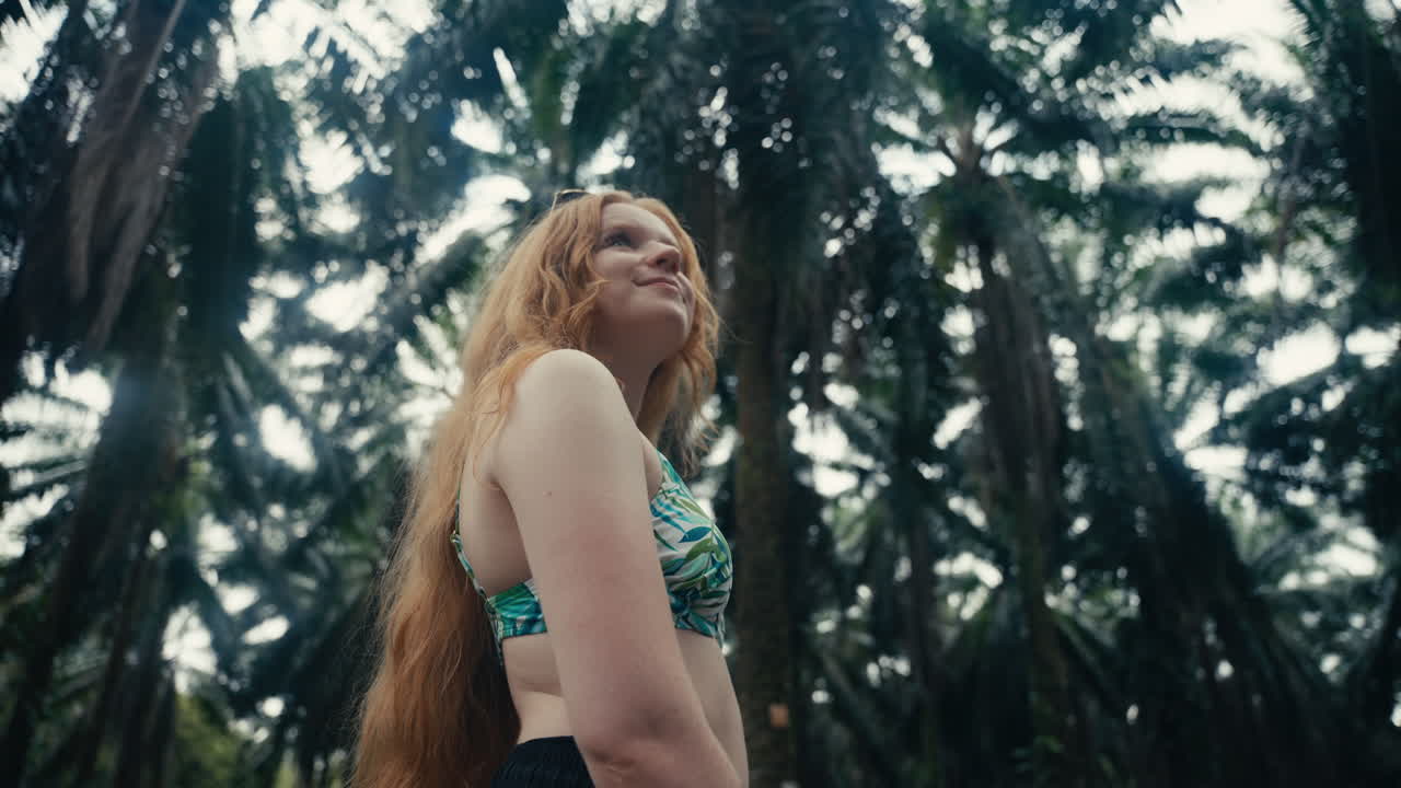 Woman in palm tree forest