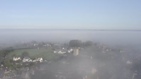 drone shot orbiting islip church in mist 02