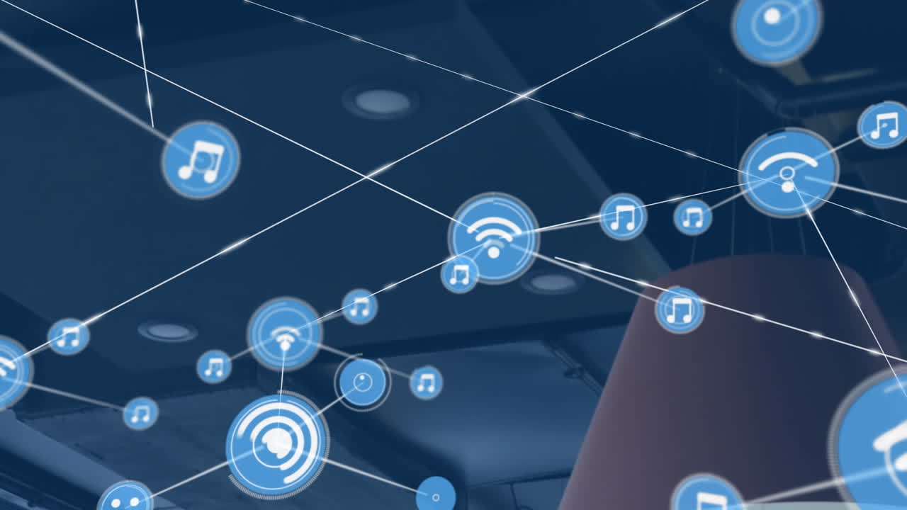 Animation of icons connected with lines over low angle view of table lamp and ceiling of office