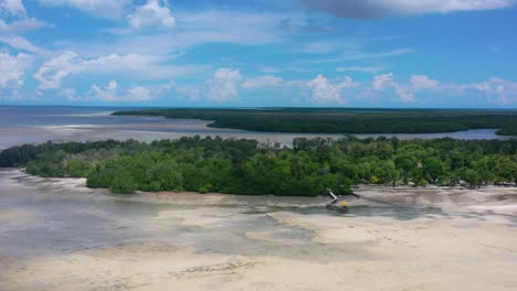 wide-aerial-view-of-Leebong-Island-coastline-at-low-tide-on-sunny-day-with-blue-sky-in-Belitung-Indonesia