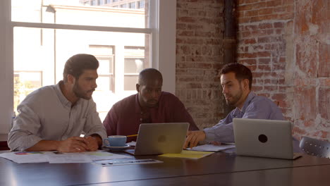 slow motion shot of creative brainstorming meeting in office