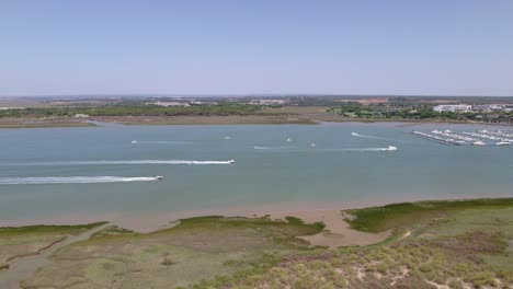 Motor-boats-sailing-and-white-wakes-in-the-estuary