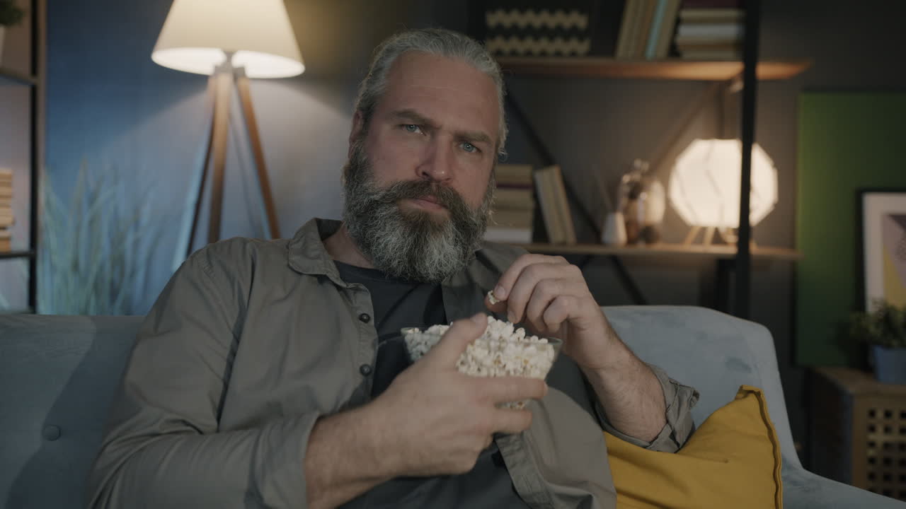 Man watching movie with popcorn