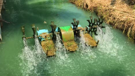 Working-water-purification-machine-in-a-small-canal-farming-at-an-organic-farm-in-Thailand