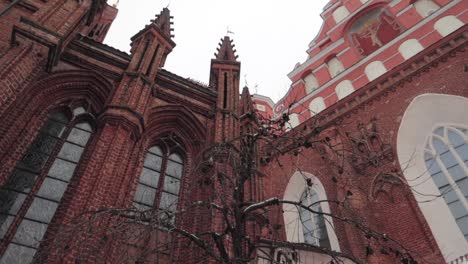 low angle shot of a red brick church on overcast day panning right