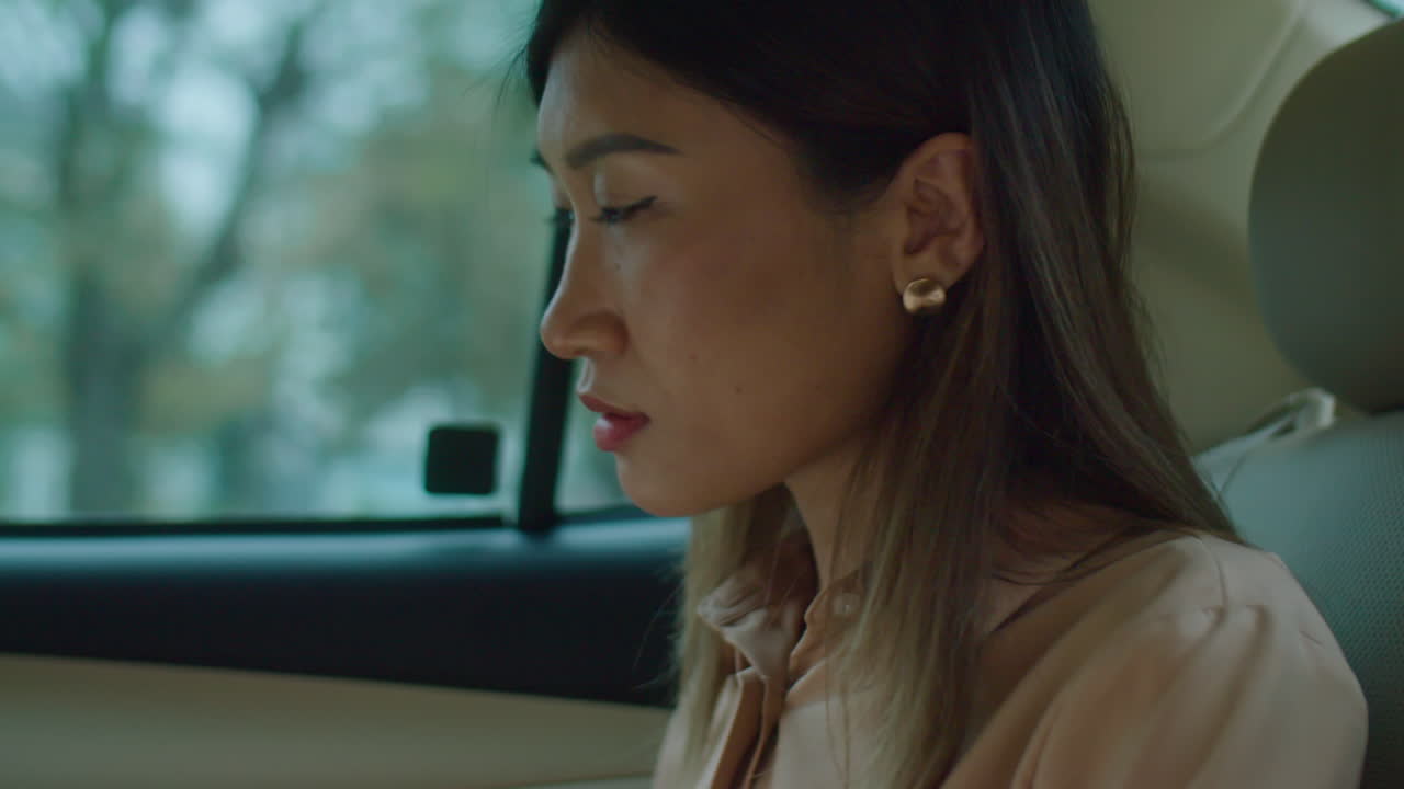 Businesswoman Working Online on Laptop in Taxi