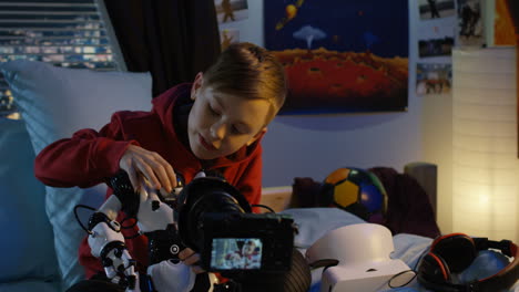 boy vlogging with robot toys in his bedroom