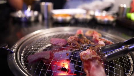 grilling pork and beef on a barbecue grill