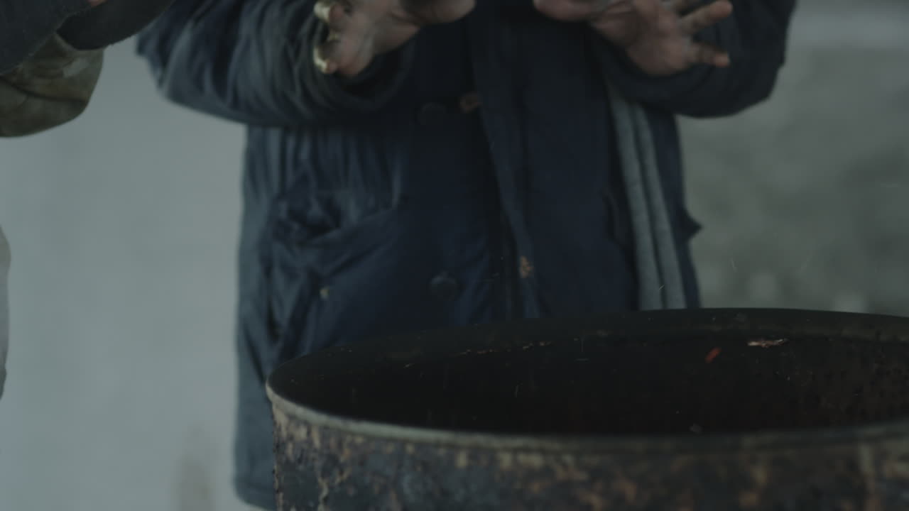 Homeless Men Warming near Fire Barrel