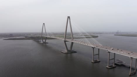 low panning aerial shot of ravenel bridge from patriot's point on a gloomy day in mount pleasant, south carolina