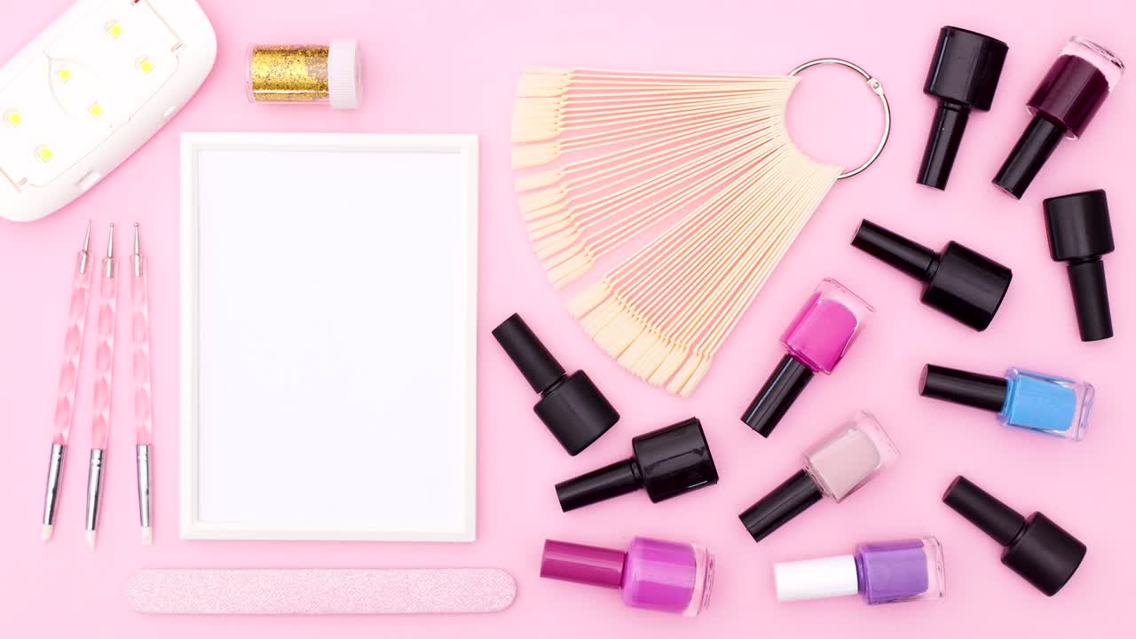 Professional nail manicure tools and accessories appear on pink theme. Stop motion