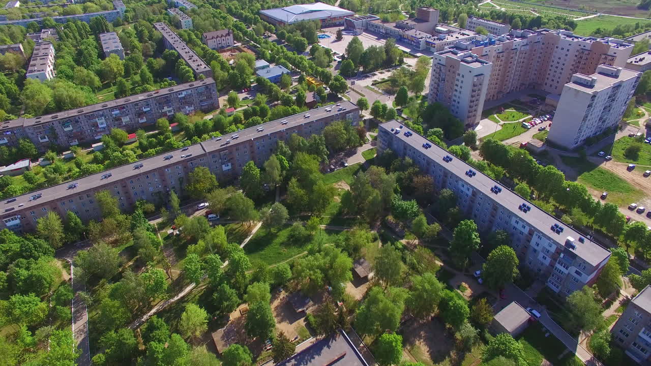 Long blocks of flats in the residential area. Green quarters with multi-storied buildings in Ukrainian city.