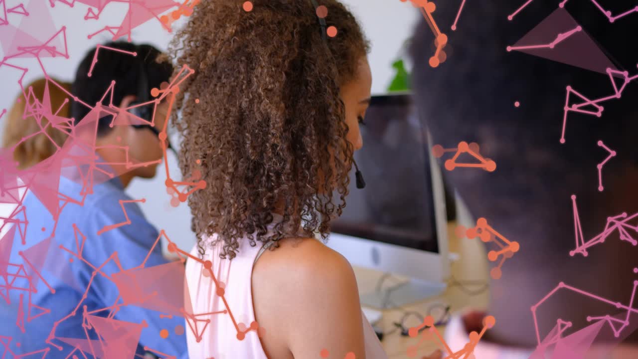 Camera pulling back, headset user working monitors revealing help desk team, particles obscuring