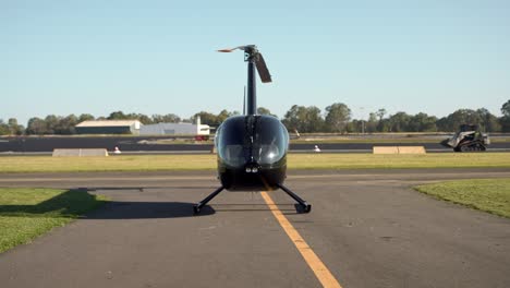 pilot walking near helicopter at airport