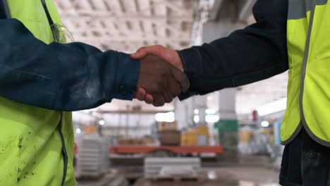 men shaking hands in a marble factory