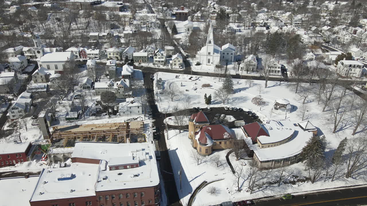 Aerial wide angle shot of snow covered City of Bath, ME, USA.  Sideway tracking shot.