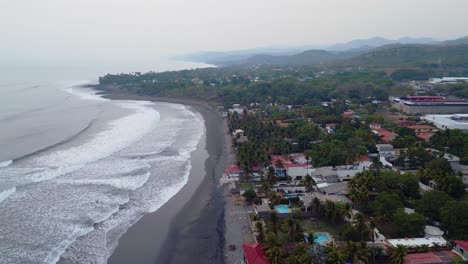 el salvador beach, surf city, la libertad beach houses panoramic drone view of the shoreline early in the morning with haze