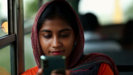 young woman using smartphone on a bus