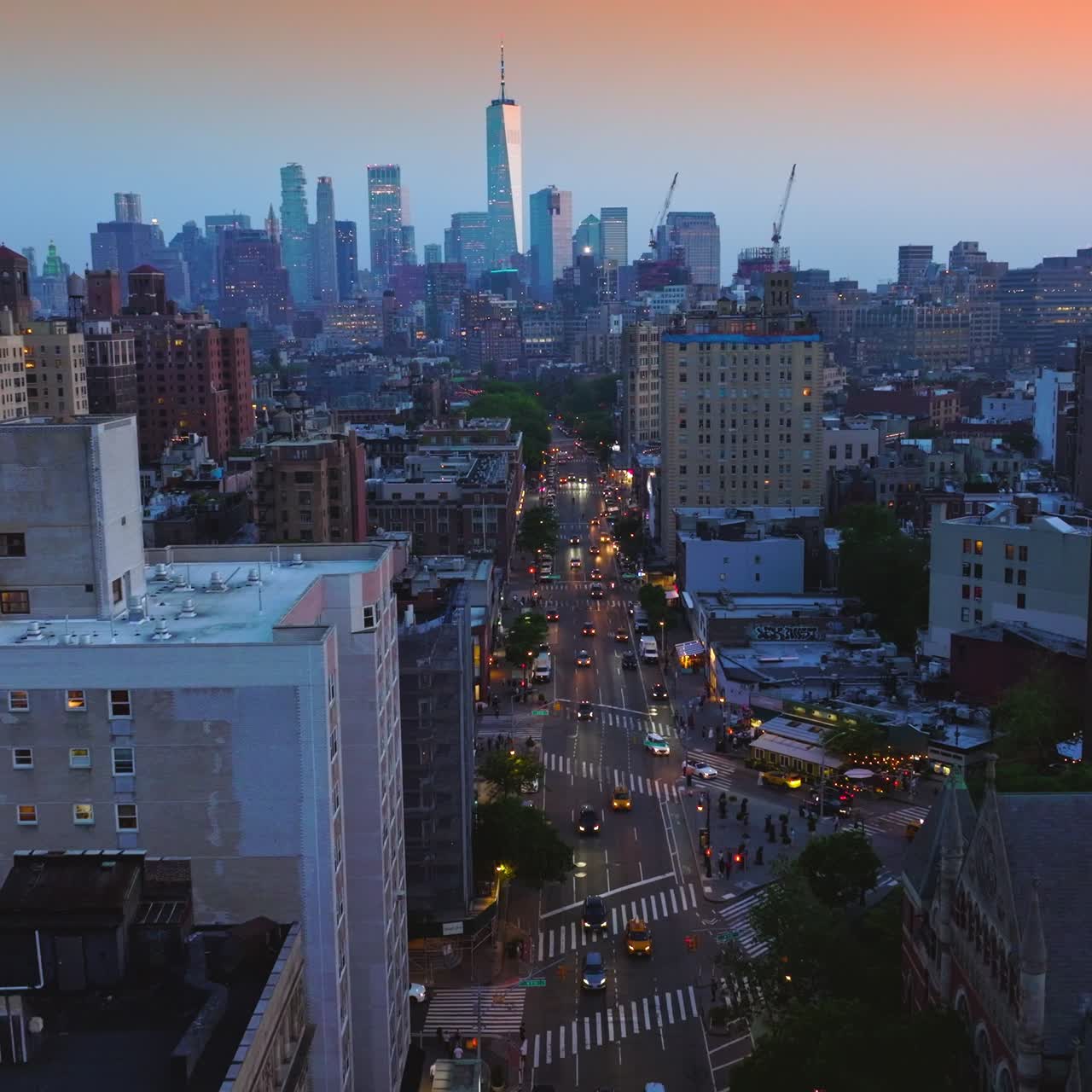 Beautiful building with clock tower and amazing highlight. Drone footage over the wide road with busy traffic. Aerial perspective