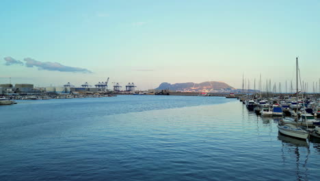 Algeciras-harbour-port-on-bright-sunny-day,-sailing-yachts-and-calm-sea,-aerial-overview