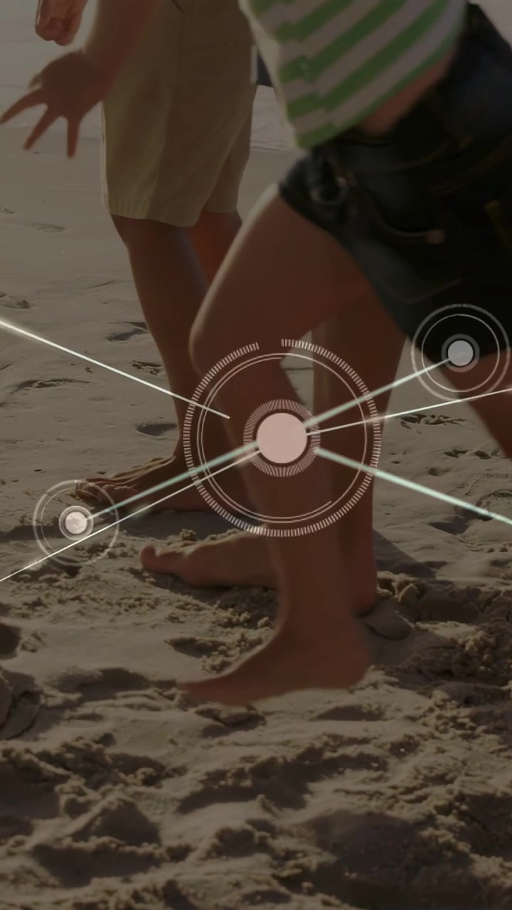 Vertical video: Dad walking two kids on shore, feet stepping causing HUD mapping prints for tech
