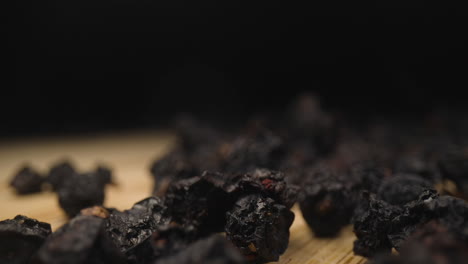 Dried-blueberry-Vaccinium-myrtillus-on-wooden-table-macro-close-up-ultra-detailed-dehydrated-fruit-snack