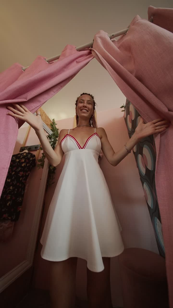 Woman in a pink dress in a dressing room