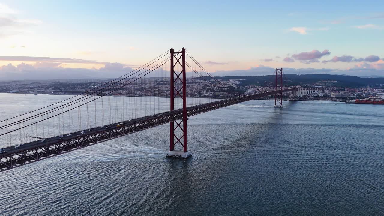 Drone footage showing Lisbon bridge and Tagus River with traffic