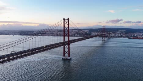 drone footage showing lisbon bridge and tagus river with traffic