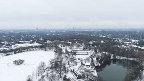 Aerial pull out from a snow covered Piedmont Park In Atlanta, Georgia.