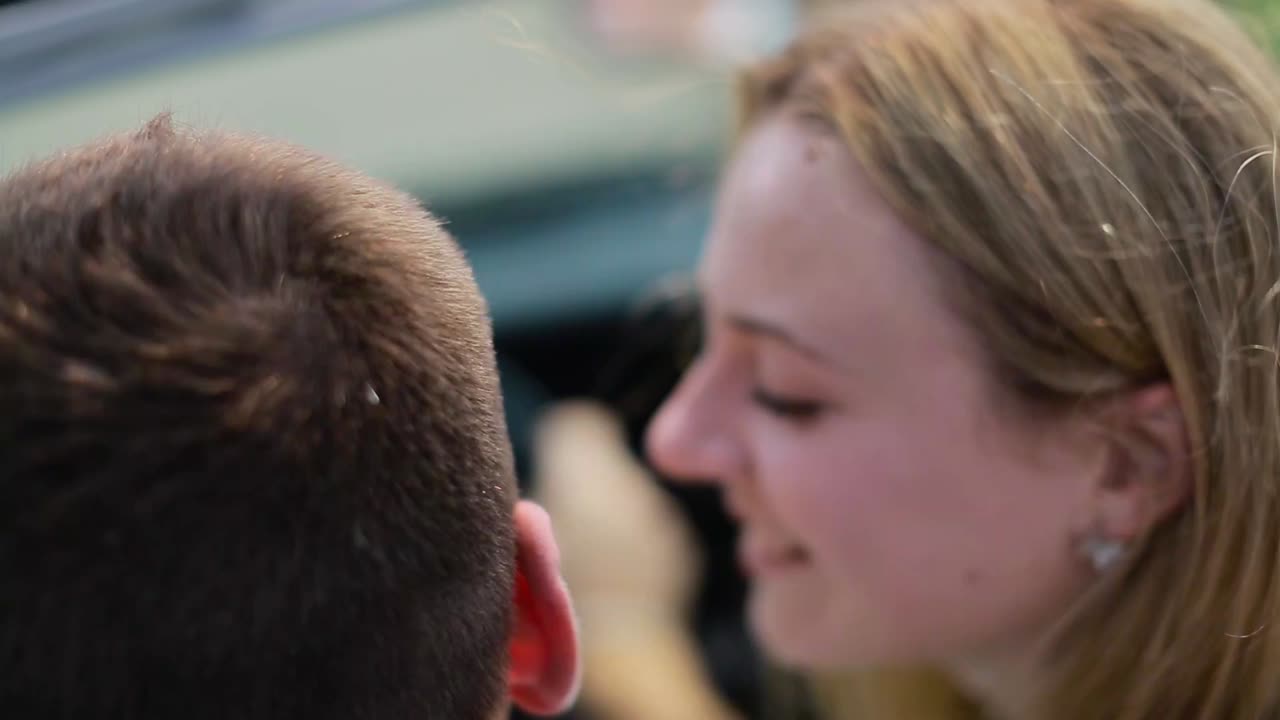 Happy Young Couple Enjoying Road Trip. Couple in cabriolet. Happy young couple enjoying road trip in their convertible while woman raising arms and smiling