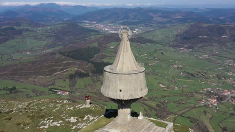 Aerial-drone-view-of-a-large-monument-statue-of-the-Virgin-of-Orduña-on-the-top-of-Mount-Txarlazo-in-the-Basque-Country