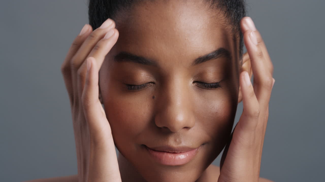 close up portrait beautiful african american woman gently touching face with hands enjoying smooth healthy skin complexion natural feminine beauty skincare concept