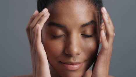 close up portrait beautiful african american woman gently touching face with hands enjoying smooth healthy skin complexion natural feminine beauty skincare concept