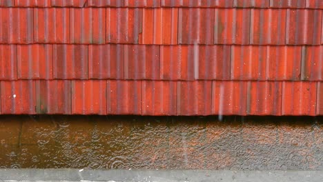 lluvia fuerte cayendo en el techo de azulejos naranja, temporada de monzones derramando agua, mal tiempo