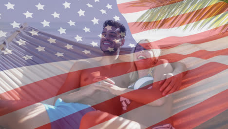 animation of american flag waving over smiling couple in love in hammock on beach