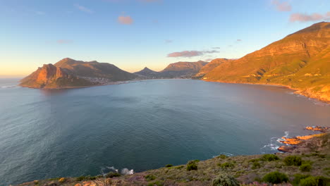 chapman peak drive sunset horizon light noordhoek hout bay marina scenic table mountain cape town epic travel road coastline cliffside view south africa lush summer wind cinematic pan left slowly