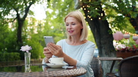 woman using mobile phone in a cafe