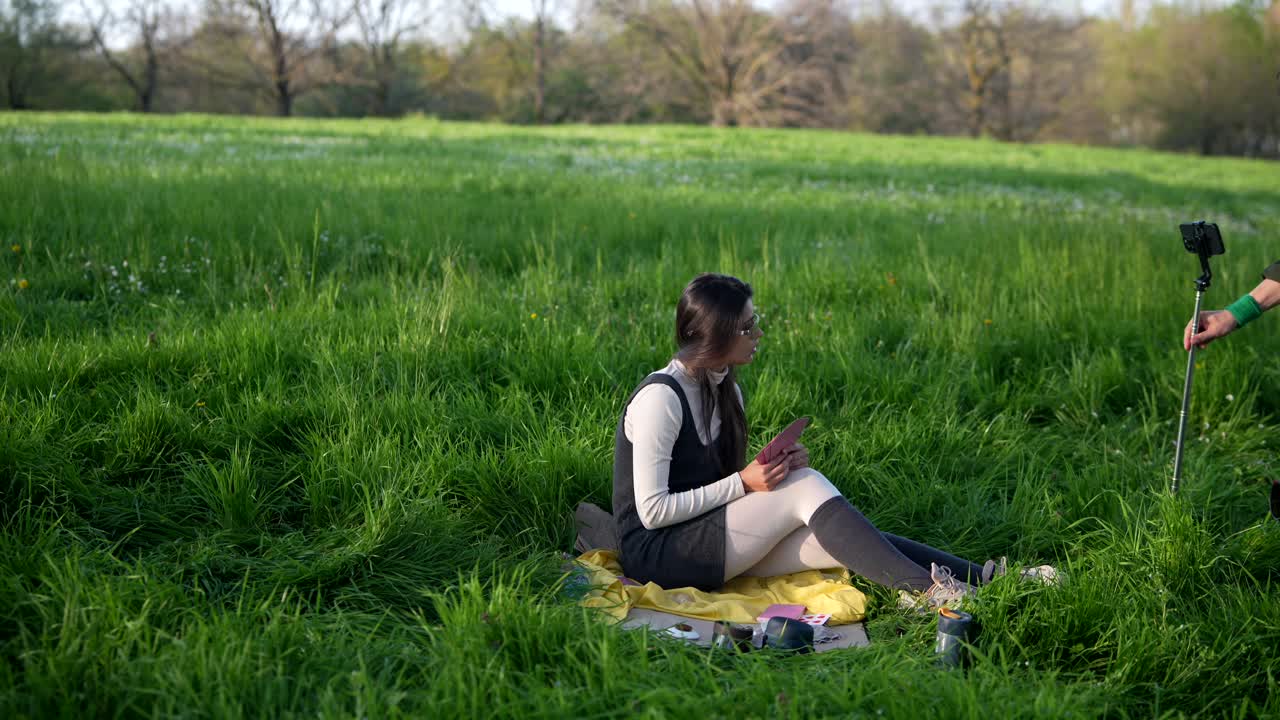 Woman in park filming herself