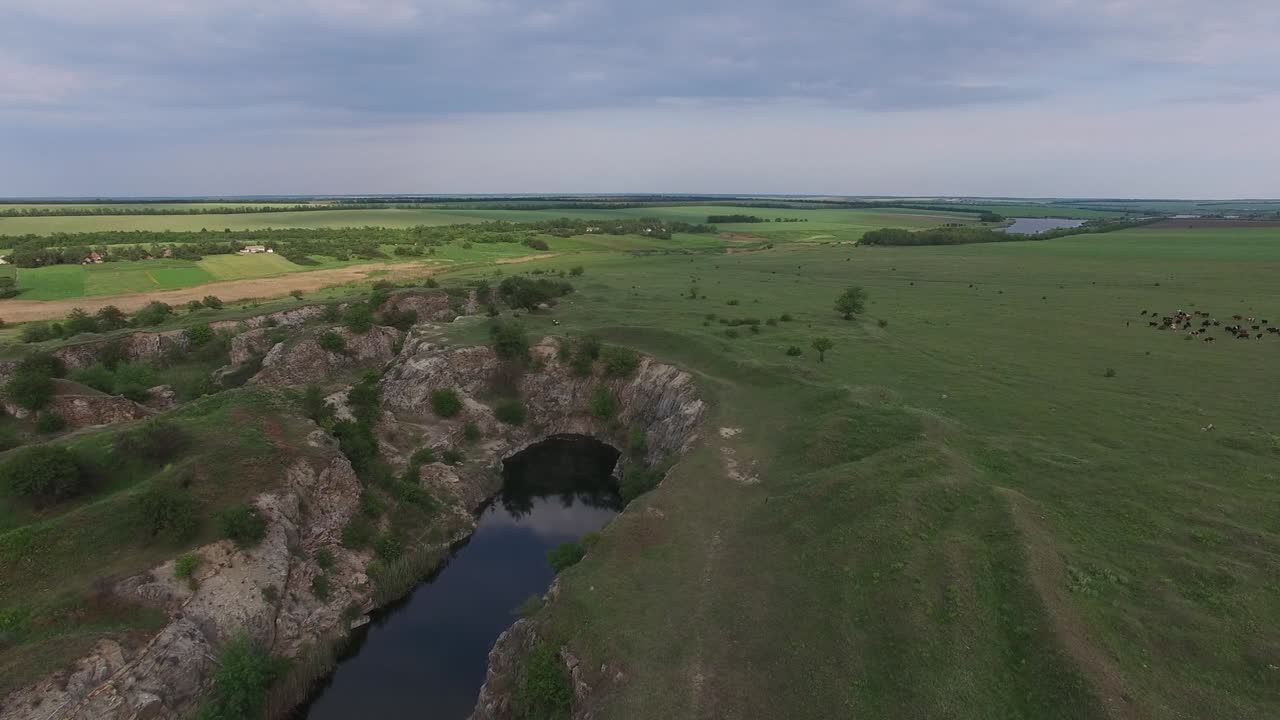 Sunset over the lake with rocky shores in the prairie
