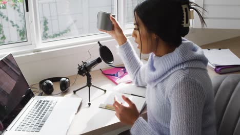 Video of biracial woman taking part in online interview on laptop at home