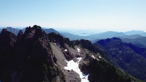 Jagged-Mountains-in-Shadow-Aerial-Pan-Left---Mackenzie-Range,-Vancouver-Island,-BC,-Canada