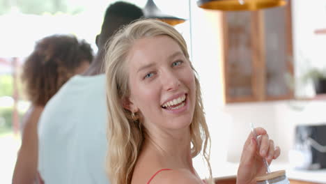 young caucasian woman smiles at a social gathering