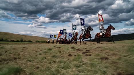 low-angle video shot of medieval knights on horseback charging across a field, showcasing dynamic