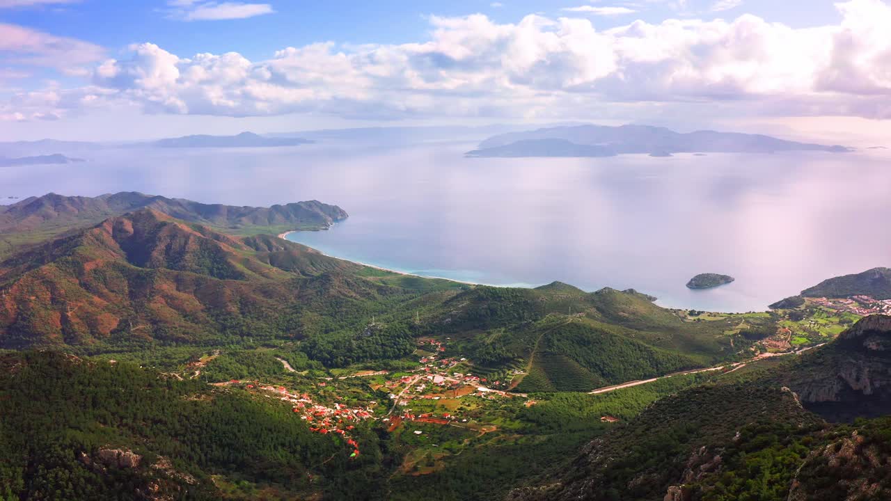 Aerial view of Emecik village in mountain valley nearby Aegean sea with Greek islands