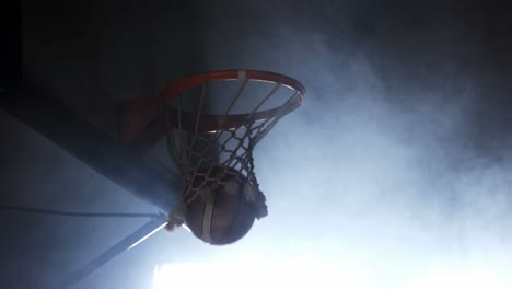 sportsman dunking basketball in hoop
