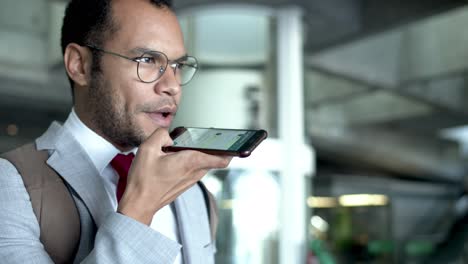 young businessman talking by smartphone