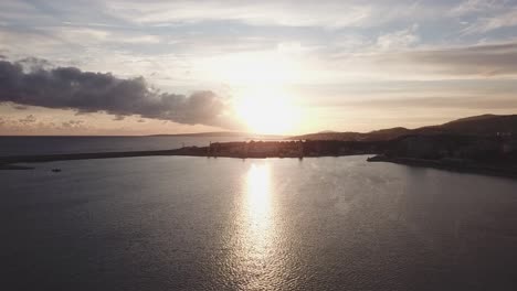 sunset over a coastal harbor